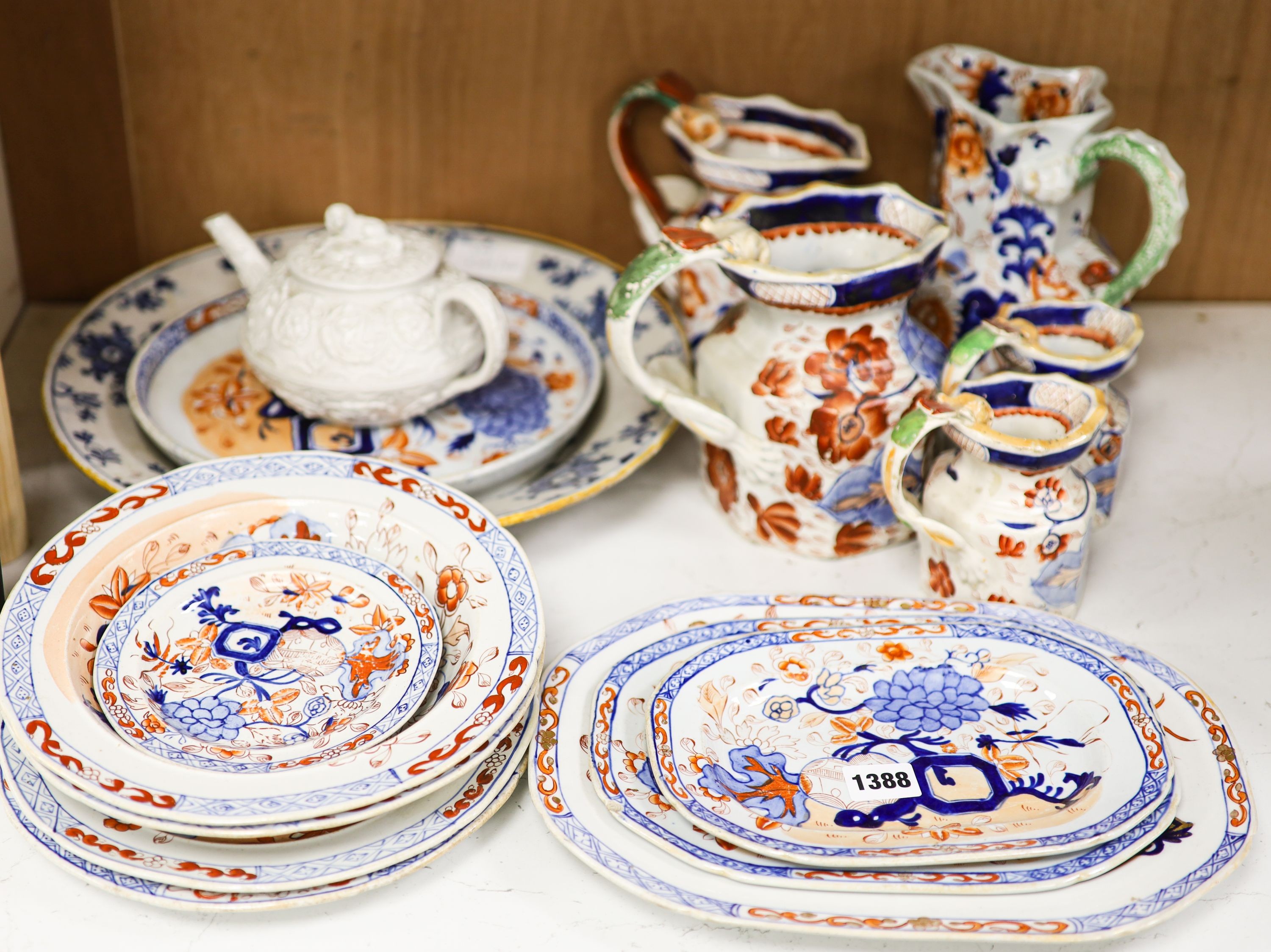 Nine pieces of Victorian Masons Ironstone, five Hydra jugs, a Delft charger and relief moulded teapot.